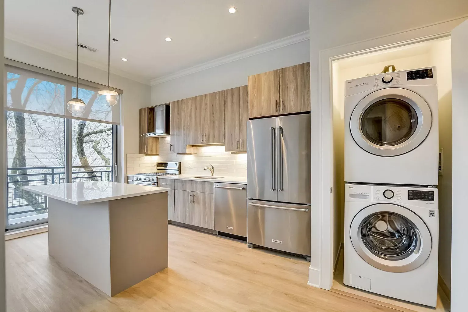 a kitchen with a washer and dryer stacked on top of each other .