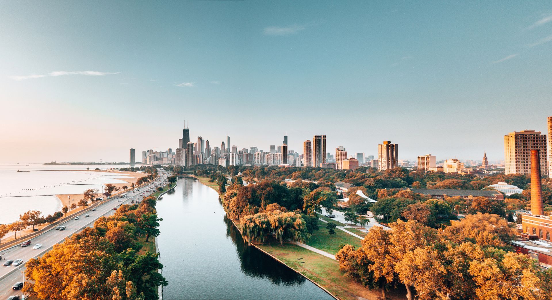 an aerial view of a city skyline with a river in the foreground .