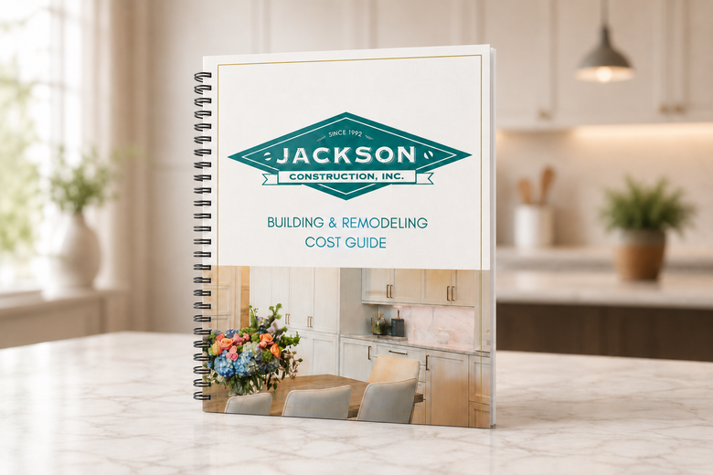 Spiral-bound Jackson publication on a table in a bright modern room, with plant and flowers in the cover image