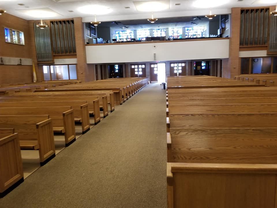 Rows of wooden benches in an empty church