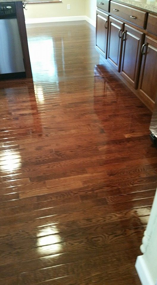 A kitchen with hardwood floors and stainless steel appliances.