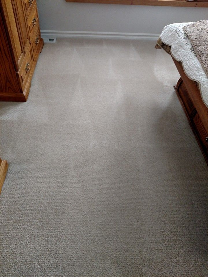 A bedroom with a bed , dresser , and carpeted floor.