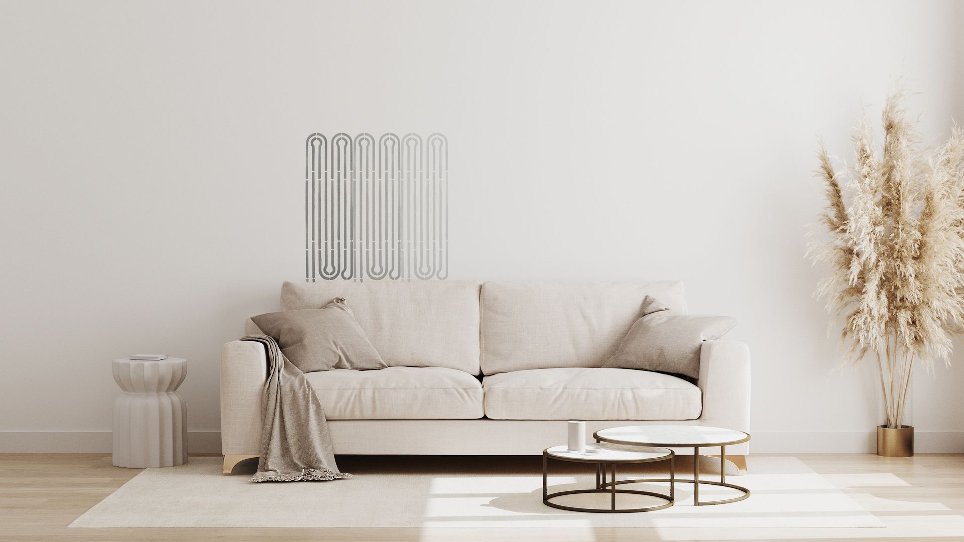 Wohnzimmer mit beigem Sofa, runden Couchtischen und dekorativem Pampasgras vor einer weißen Wand.