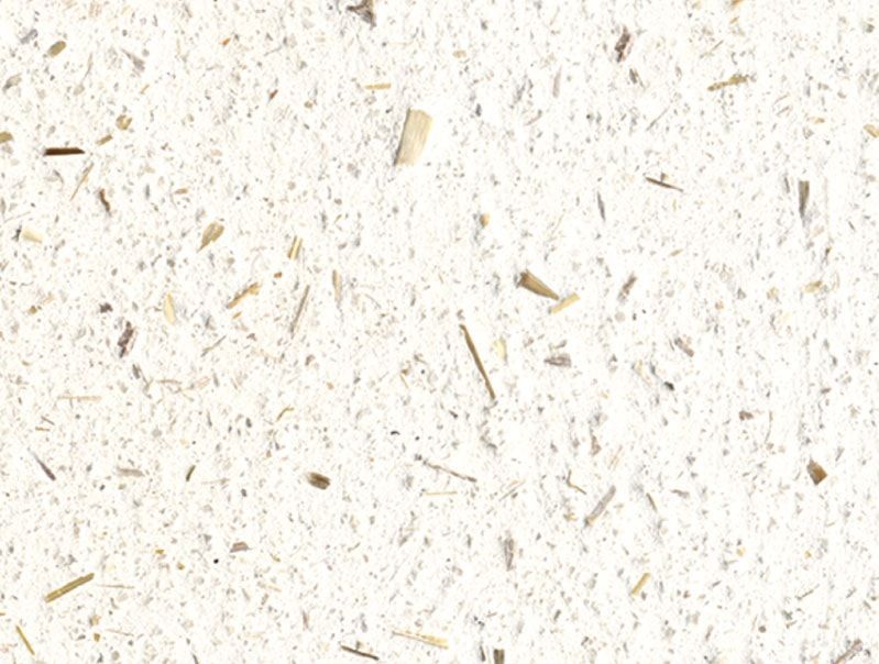 Cremefarbenes strukturiertes Papier mit überall eingebetteten Flecken aus braunen und hellbraunen Fasern.