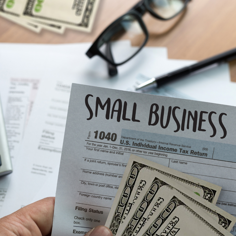 A person is holding a small business tax form