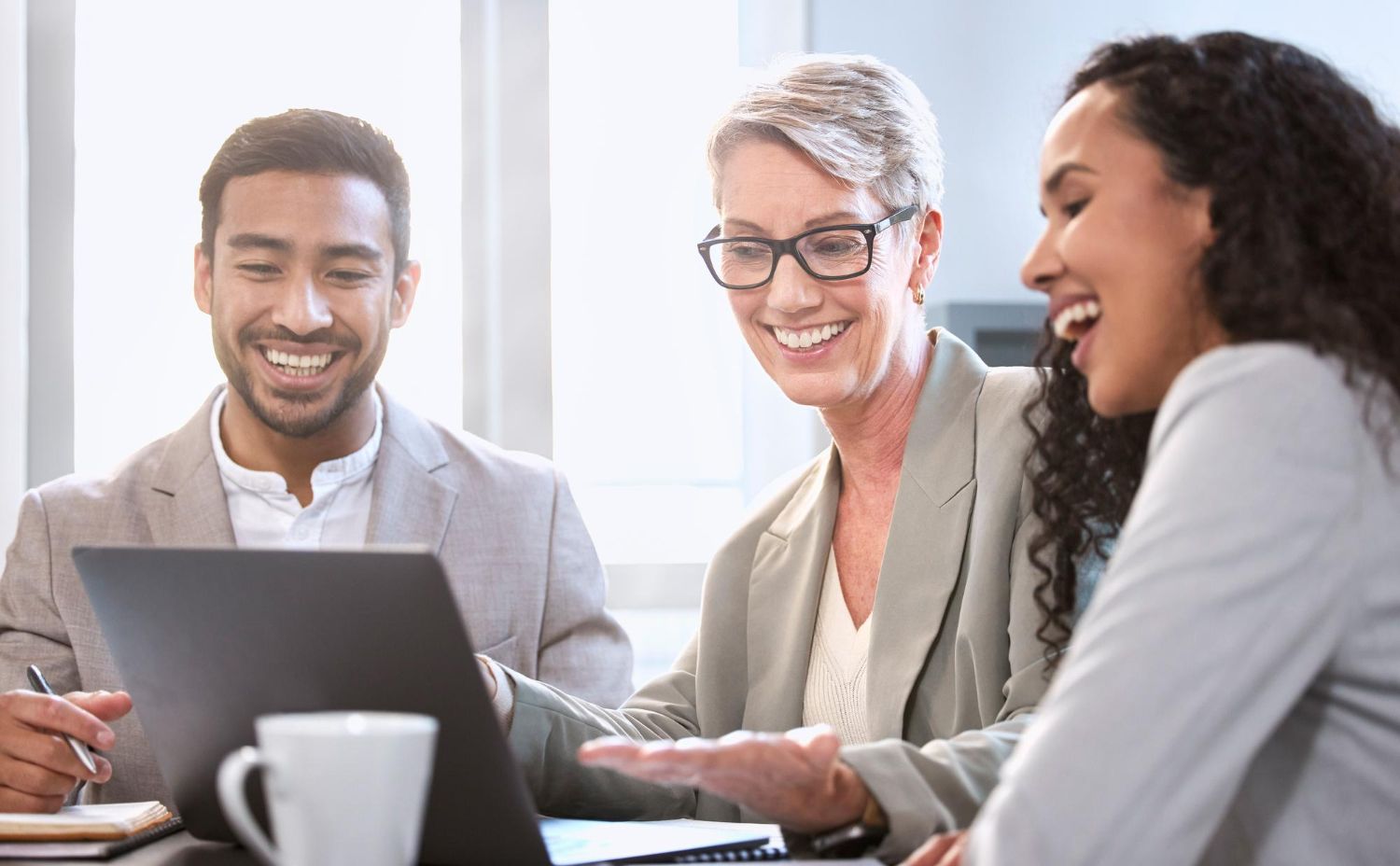 Two business professionals in suits reviewing documents, discussing strategy.