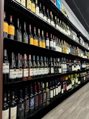 Bottles of alcohol backlit on a bar shelf.