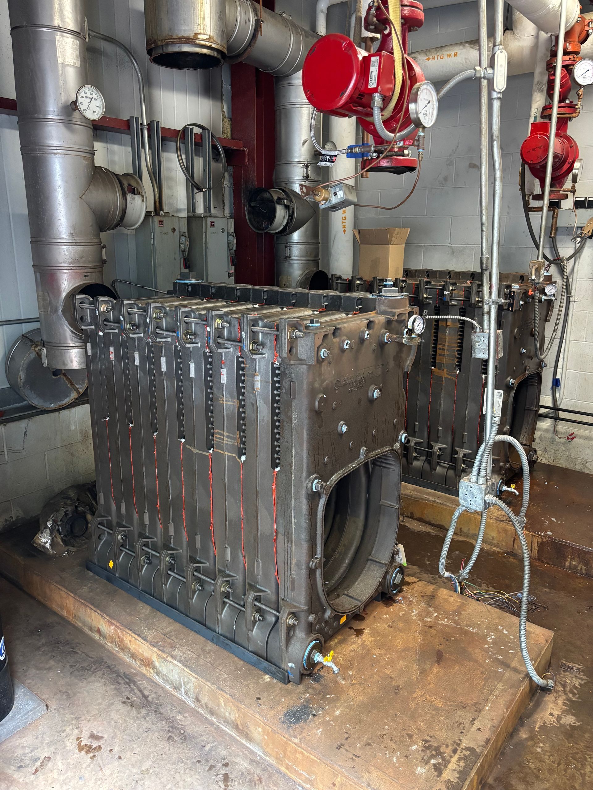 A large air conditioner is installed on the side of a house.