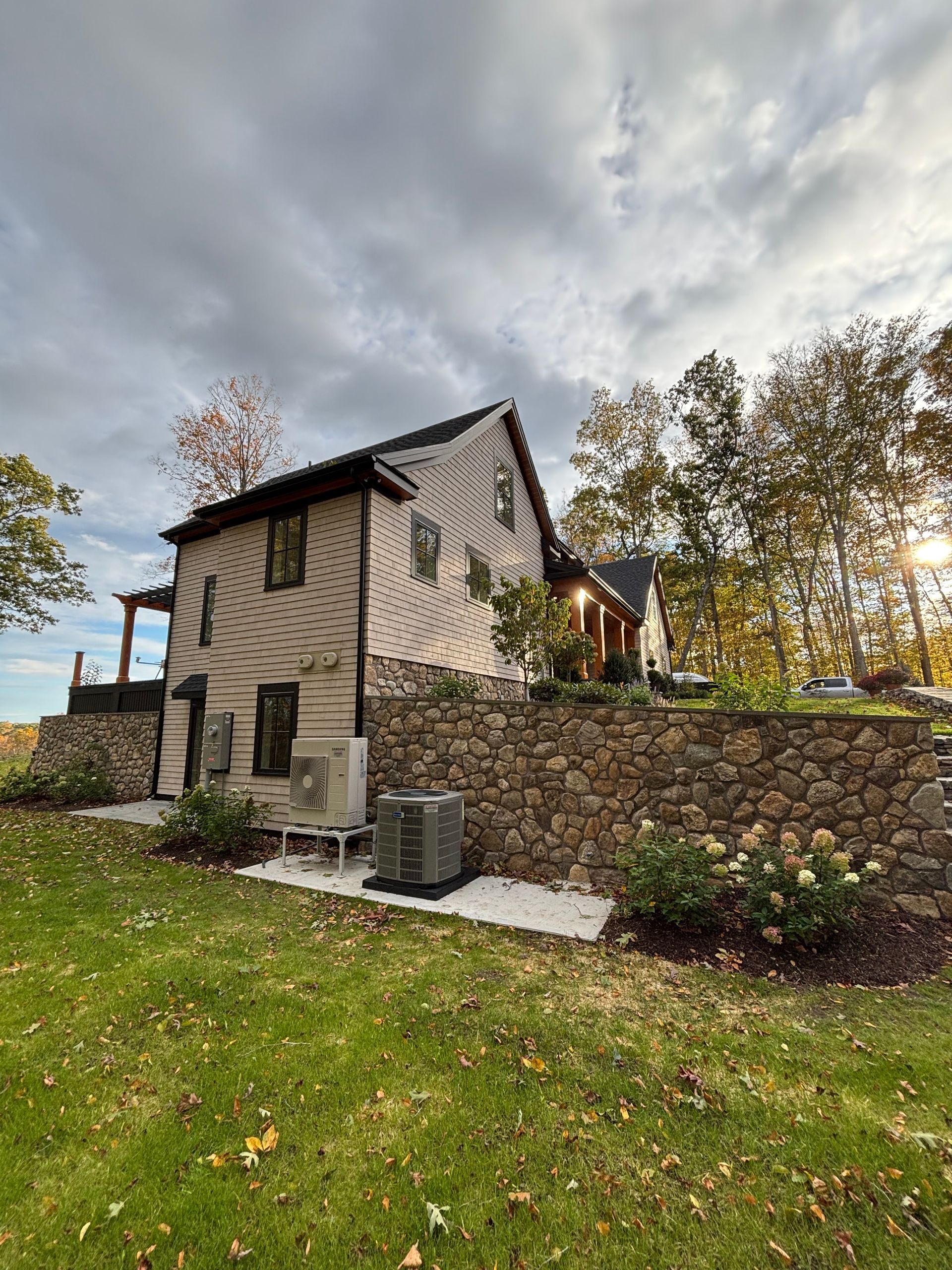 A room under construction with a ceiling fan hanging from the ceiling.
