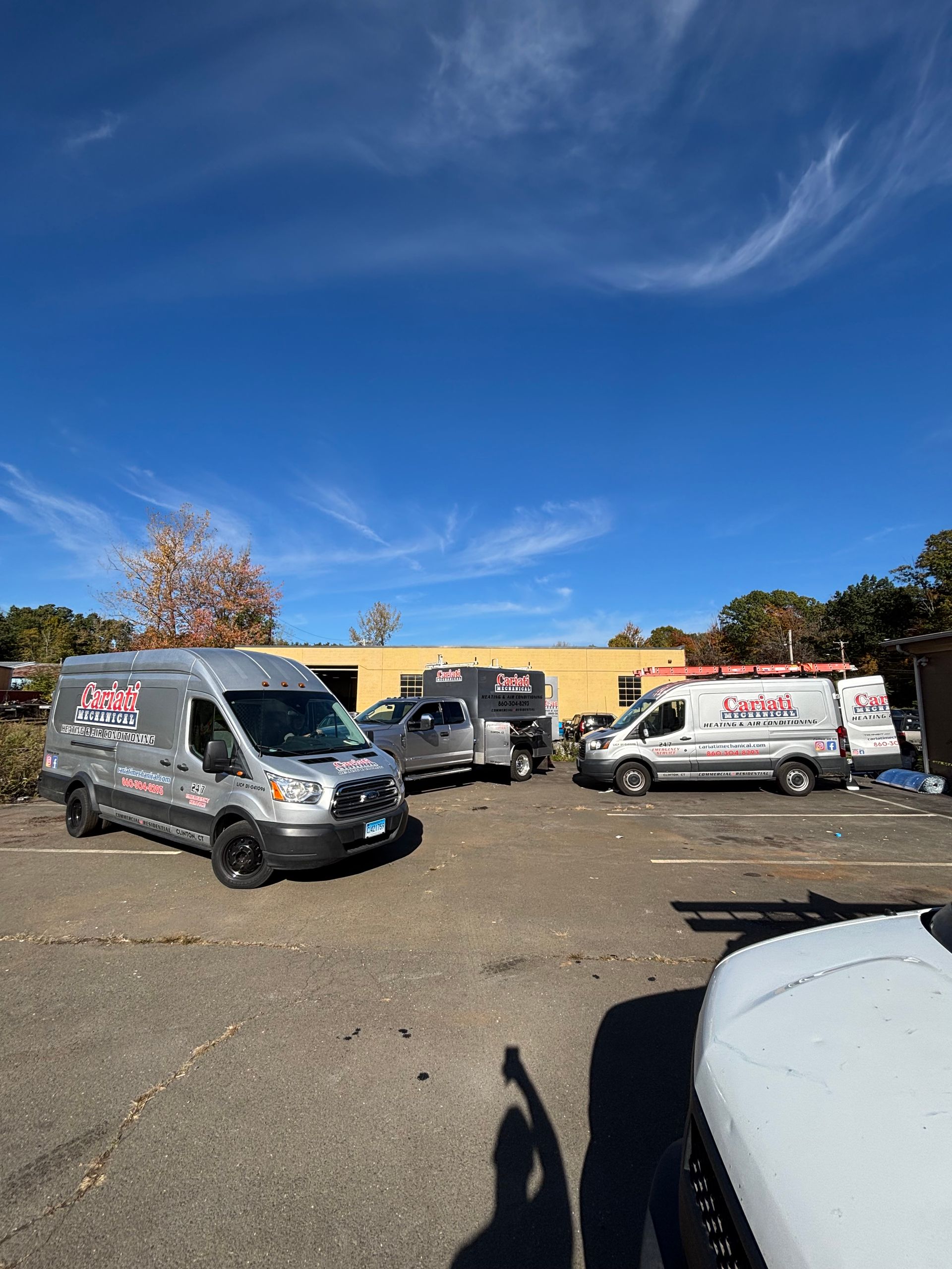 A room with a blue boiler and a lot of pipes.