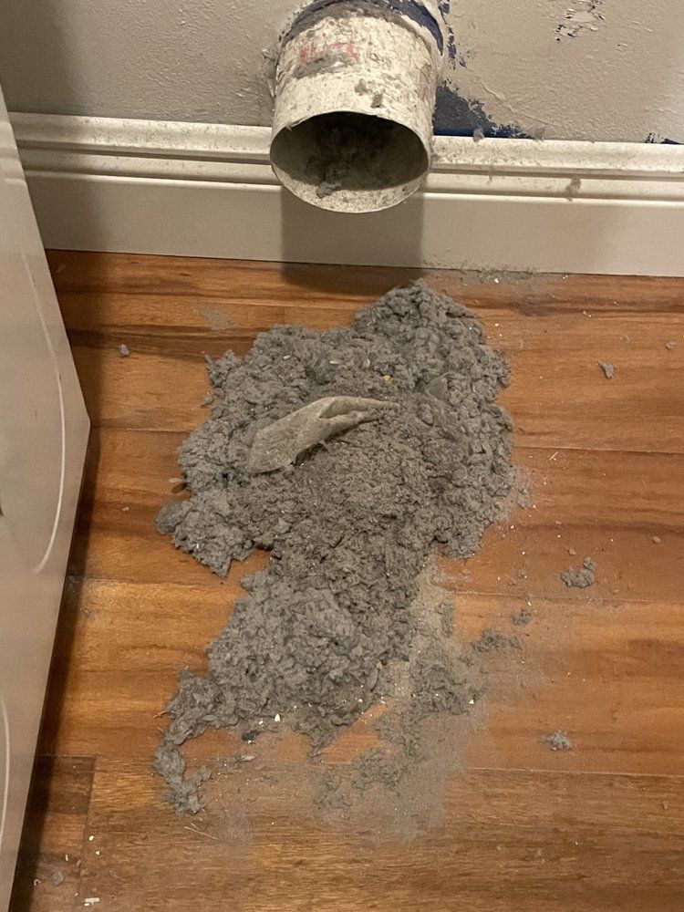 A bunch of dust is coming out of a pipe on the floor.