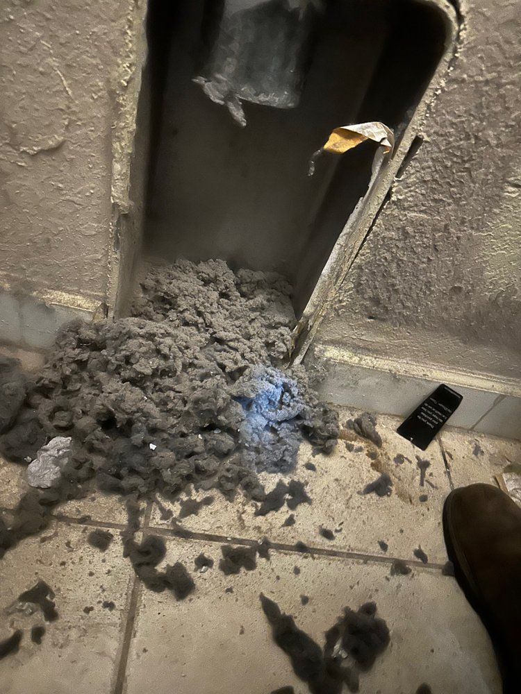 A bunch of dust is coming out of a hole in the wall.