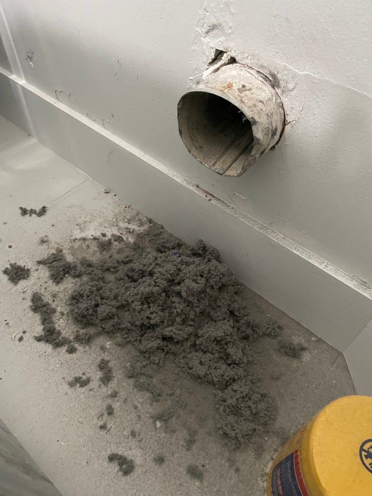 A bunch of dust is coming out of a hole in the wall.