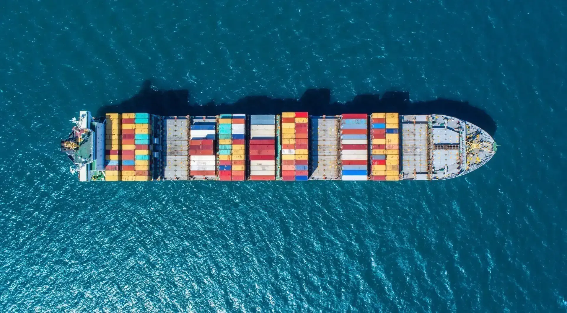 An aerial view of a large container ship in the ocean.