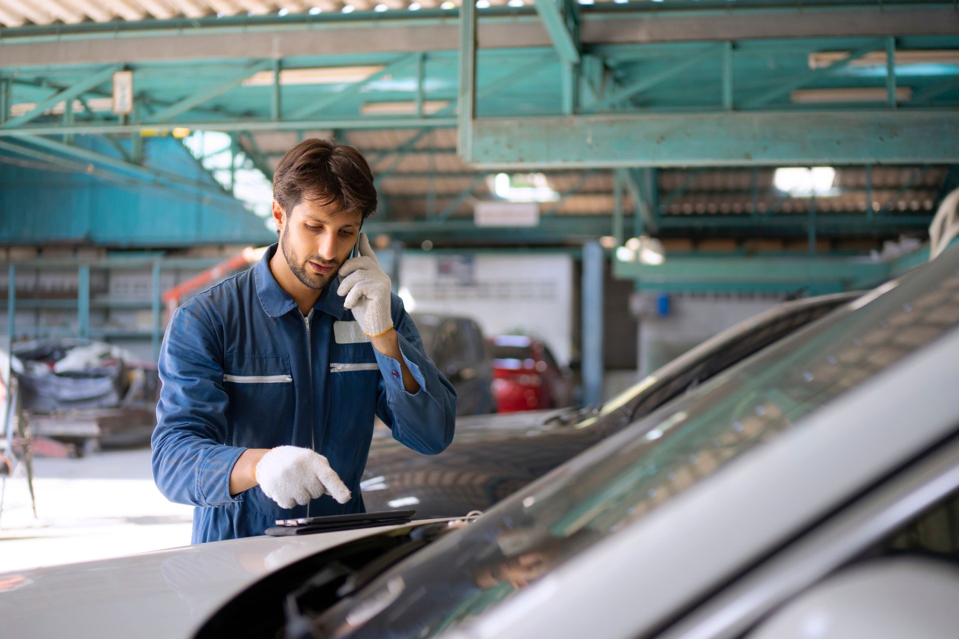 Mobile Auto Glass Repair Service Technician Fixing Windshield at Auto Shop Mobile Auto Glass Repair Service Technician Fixing Windshield at Auto Shop