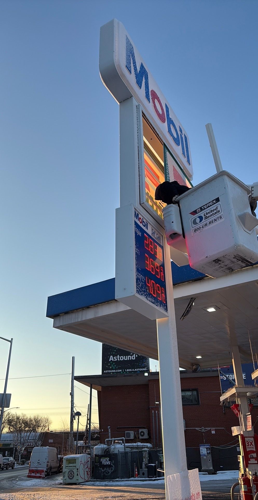 Bedroom with bed, fireplace, wooden floor, gray walls, and ceiling fan.