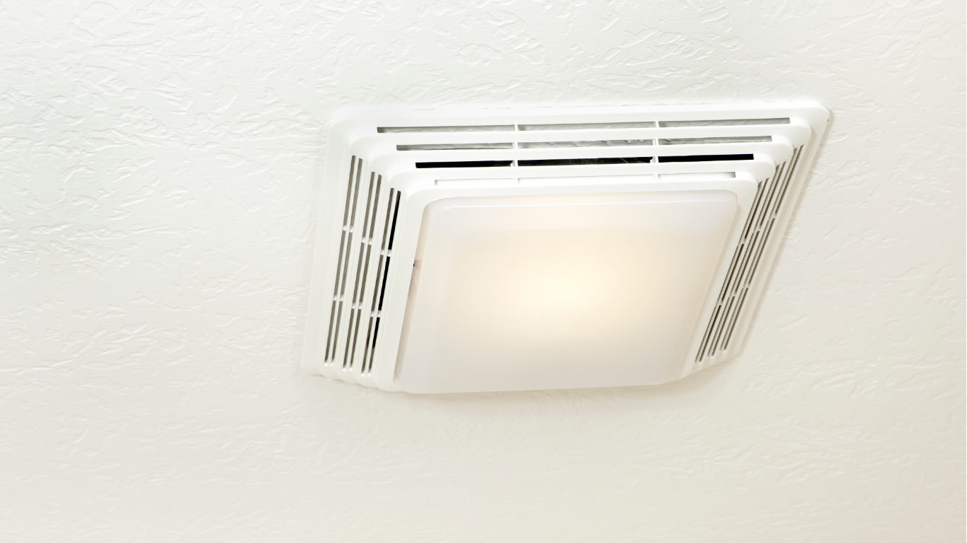 A white bathroom ceiling exhaust fan with an integrated, glowing light fixture.