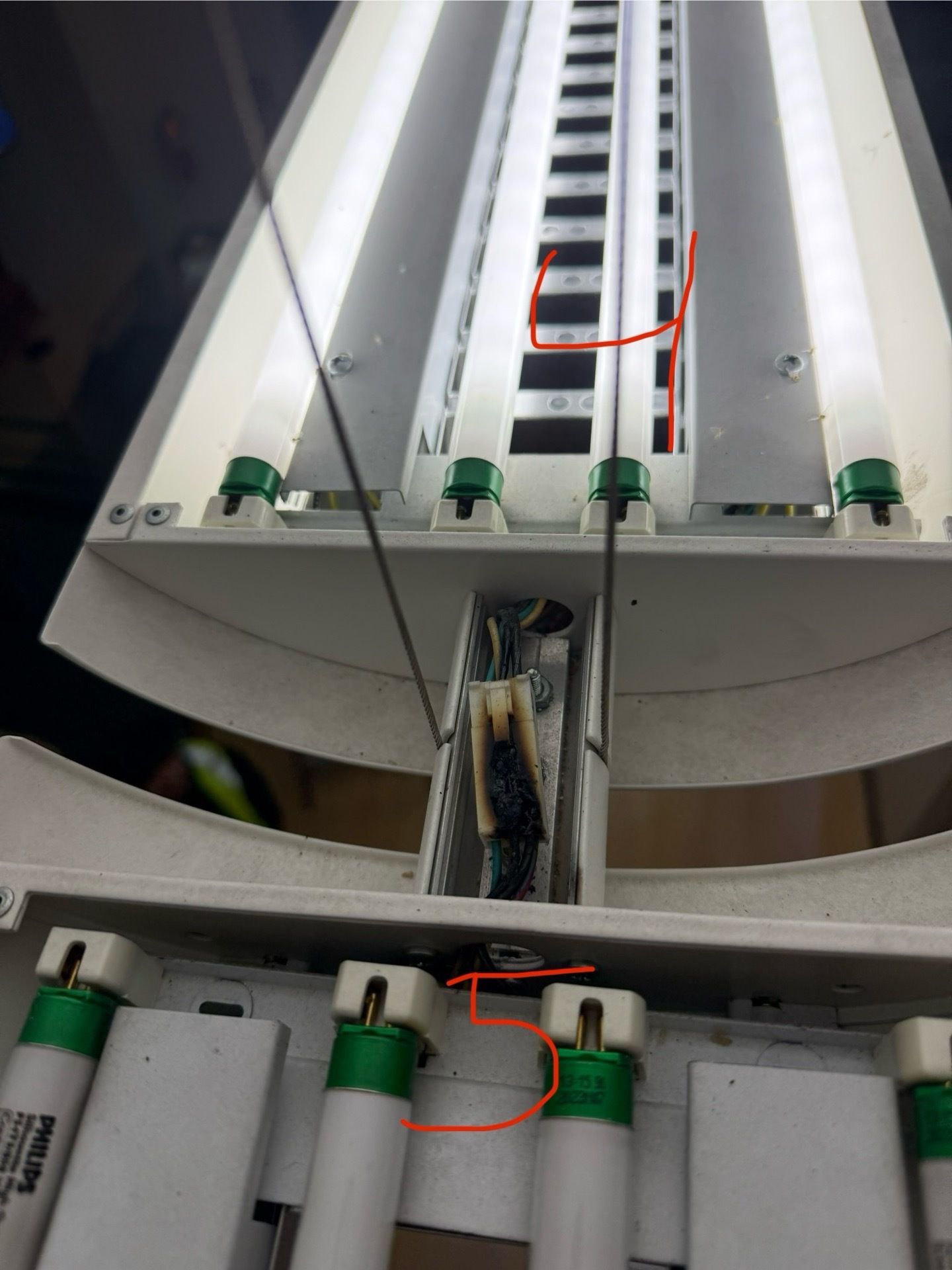Bedroom with bed, fireplace, wooden floor, gray walls, and ceiling fan.