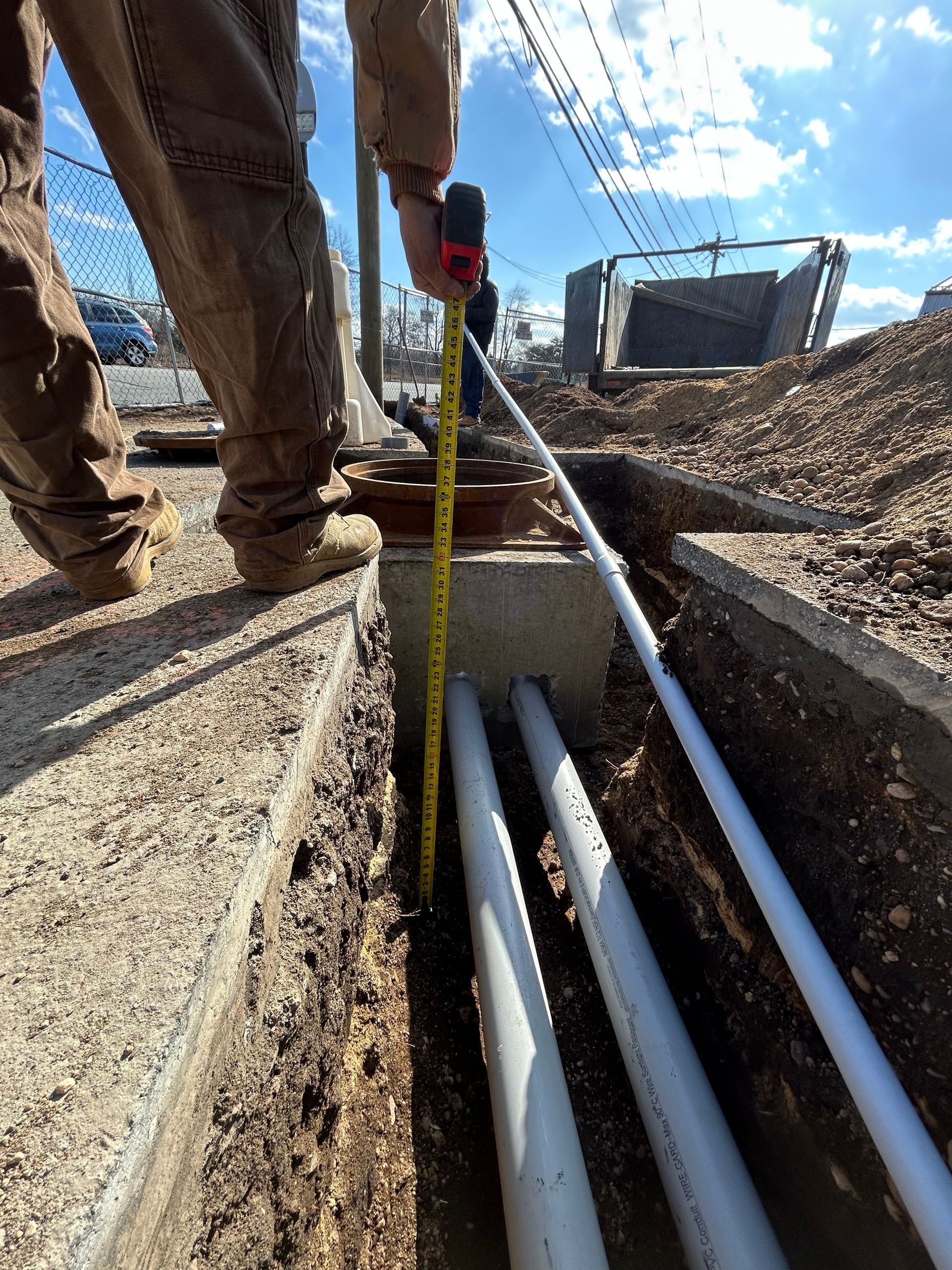 Bedroom with bed, fireplace, wooden floor, gray walls, and ceiling fan.