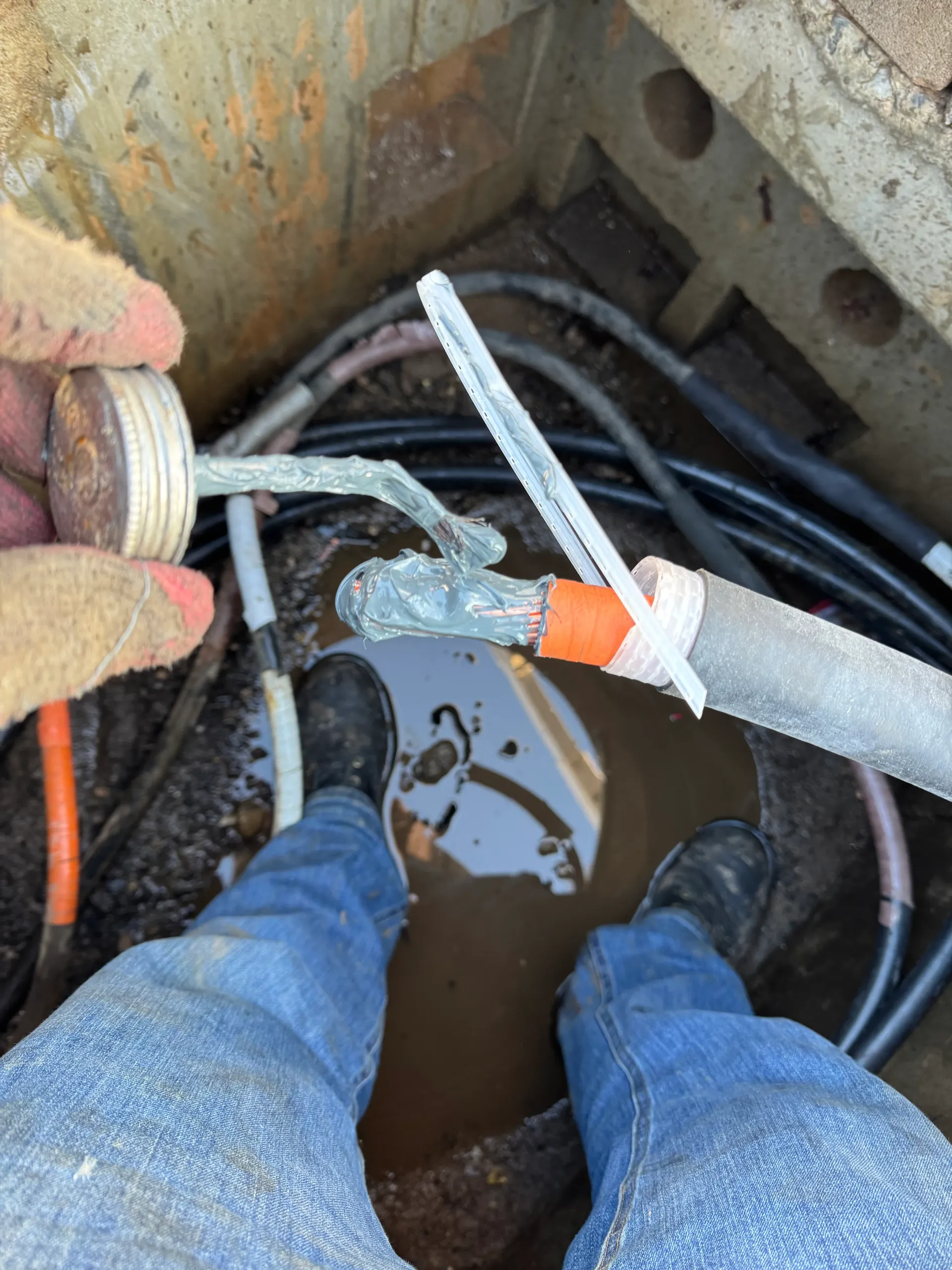 Bedroom with bed, fireplace, wooden floor, gray walls, and ceiling fan.