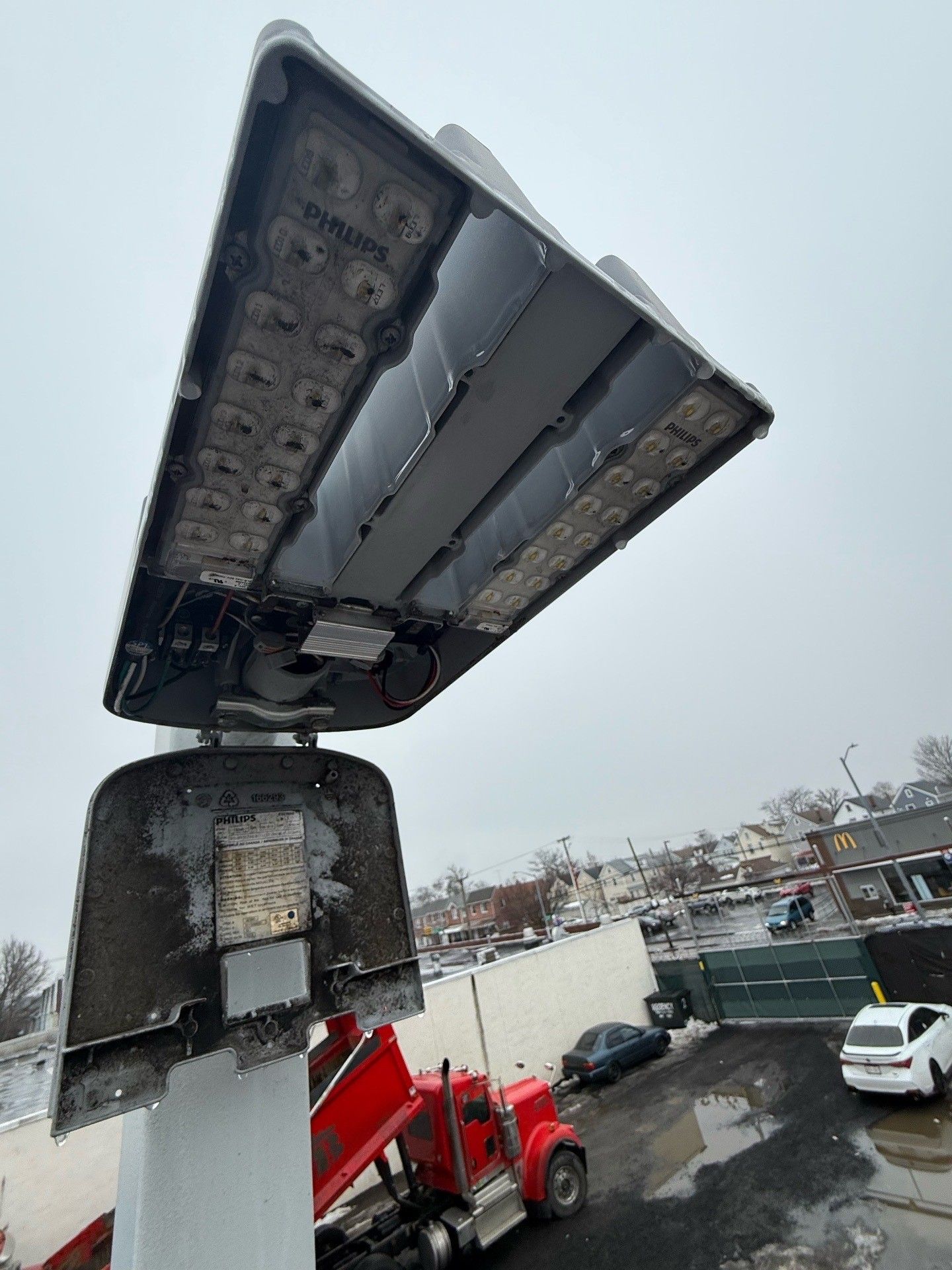 Bedroom with bed, fireplace, wooden floor, gray walls, and ceiling fan.