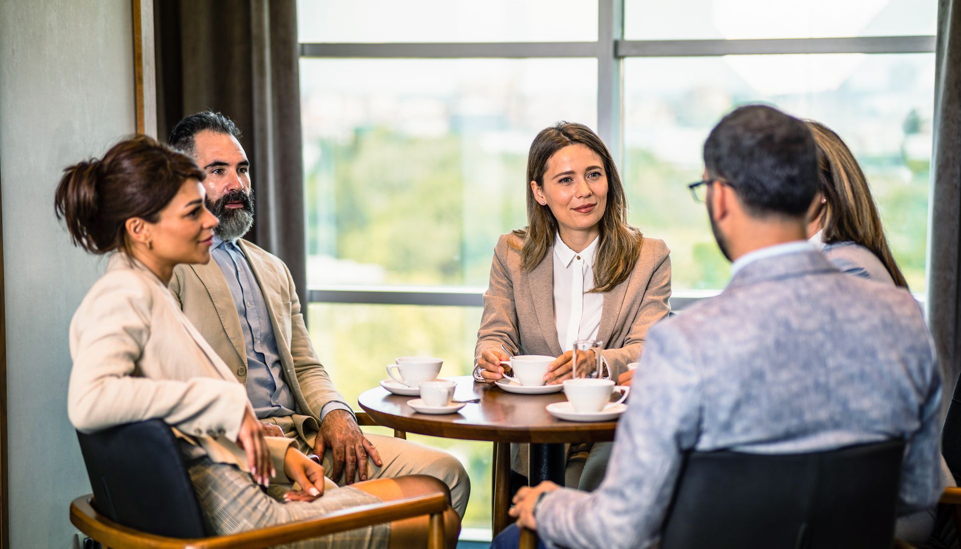 Eine Gruppe von Leuten sitzt um einen Tisch herum und hält eine Besprechung ab.
