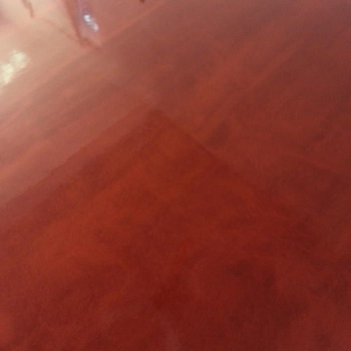 Glossy red floor with subtle patterns.