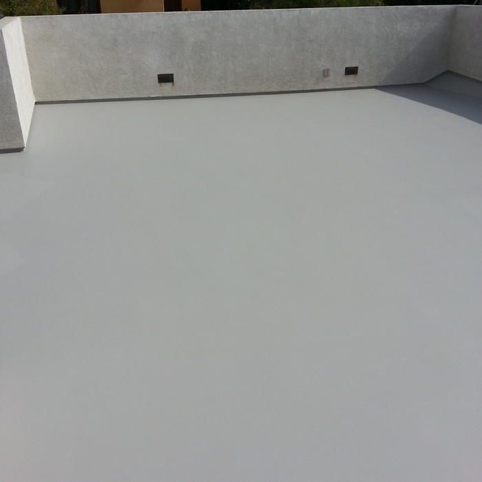 Gray flat rooftop with a textured wall, possibly concrete.