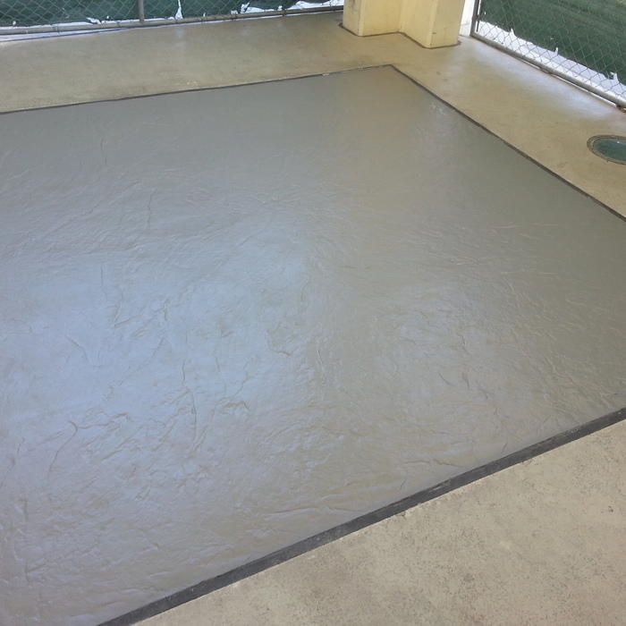 A freshly poured concrete surface on a patio. Gray, with a dark border.