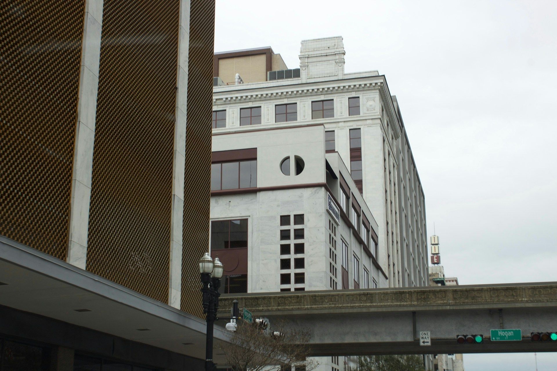 A bridge over a street with a building in the background