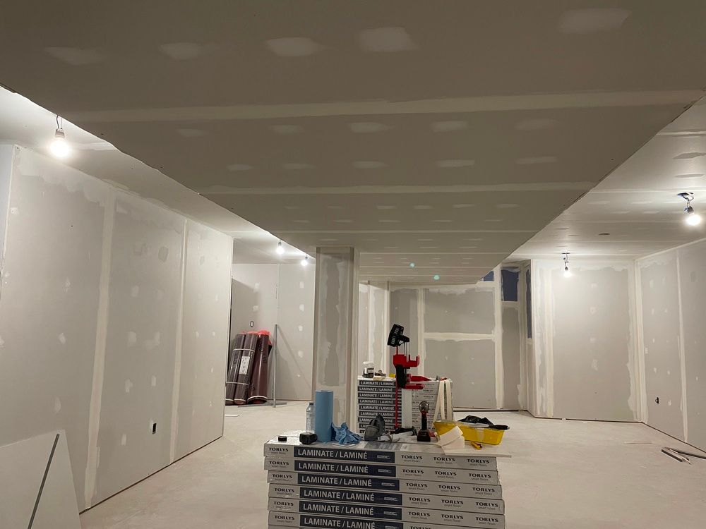 A room with a ceiling that is being built and a lot of boxes on the floor.