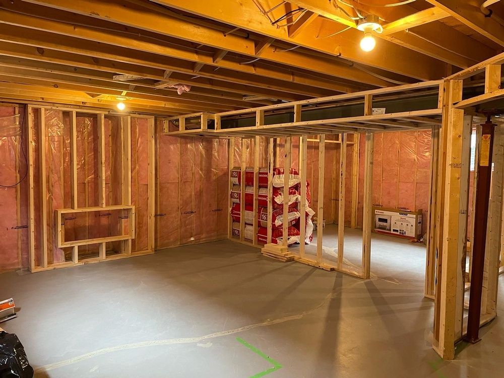 A basement is being built with wooden frames and insulation.