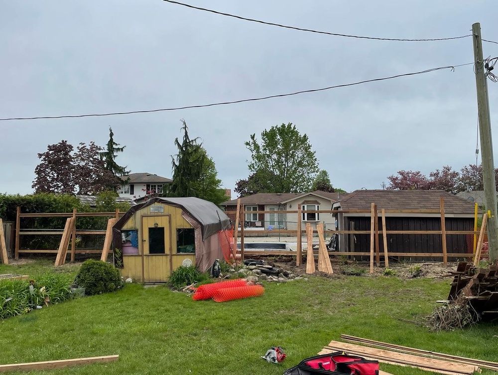 A shed is being built in the backyard of a house.
