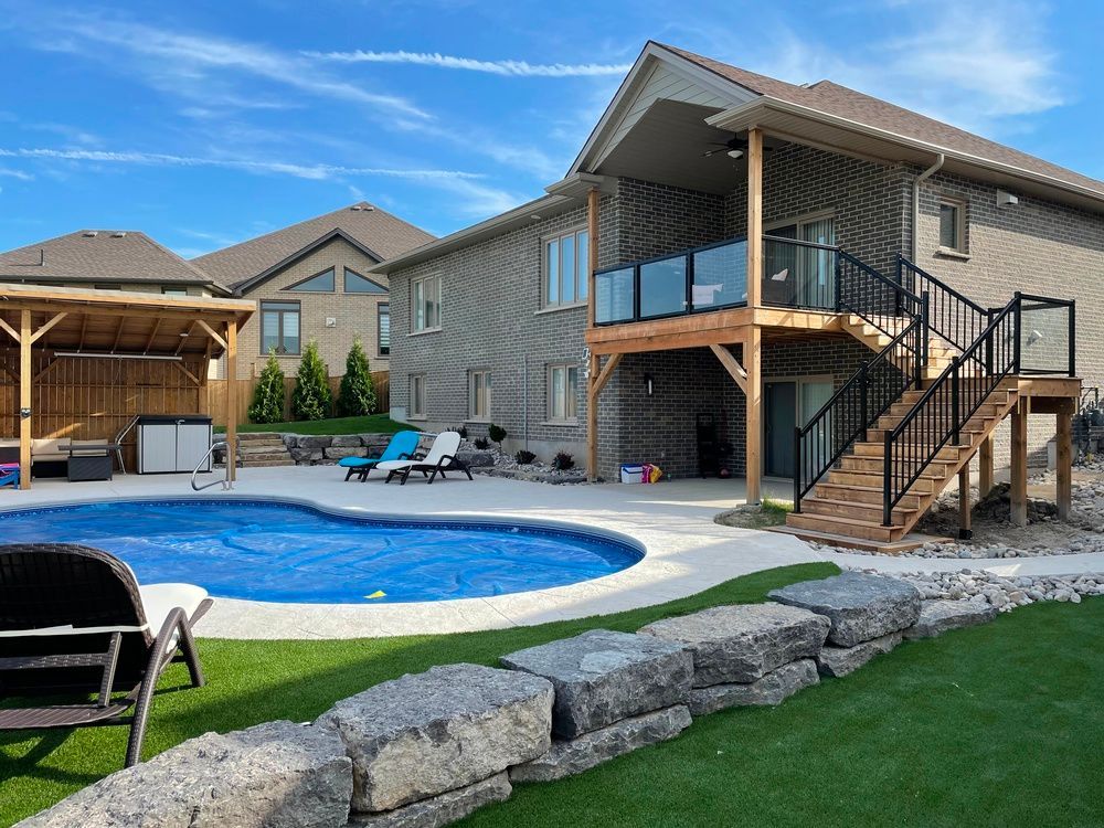 A large house with a large swimming pool in front of it.