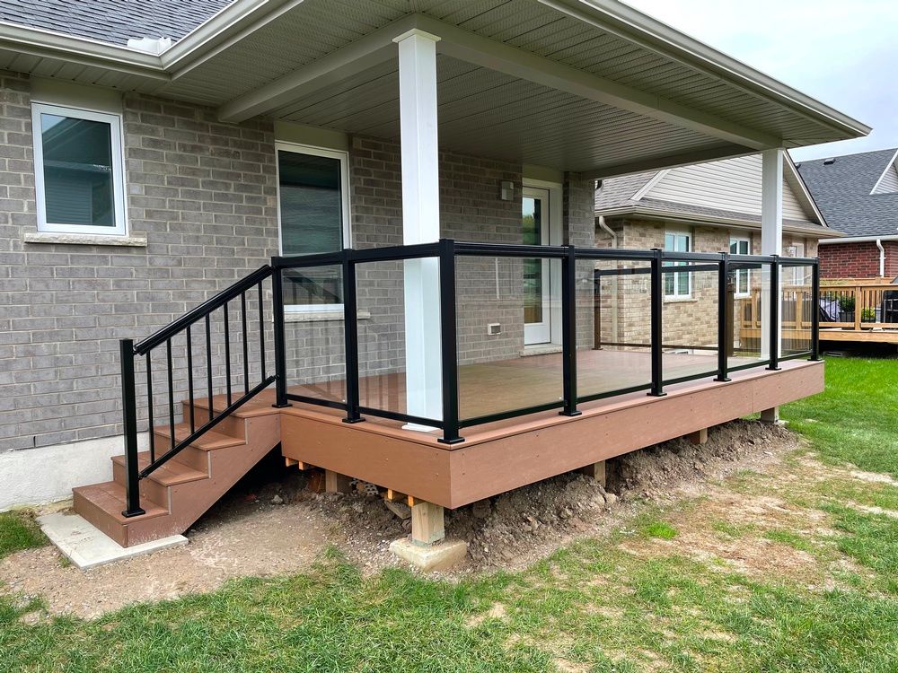 A house with a deck and stairs in front of it.