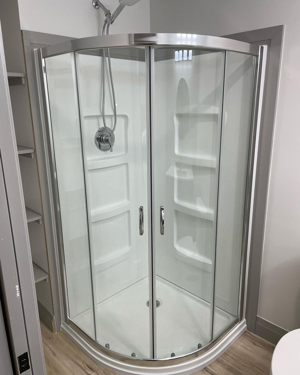 A bathroom with a shower stall and a toilet.