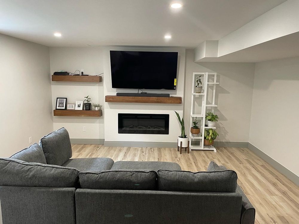 A living room with a couch , television and fireplace.