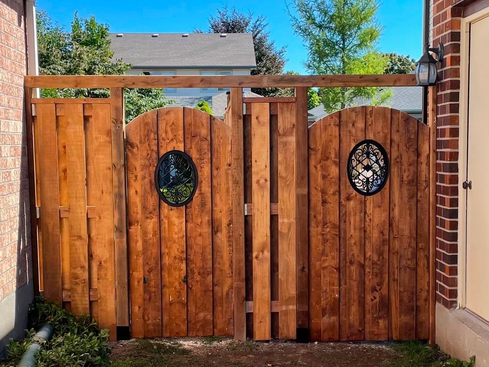 A wooden fence with a round window in the middle