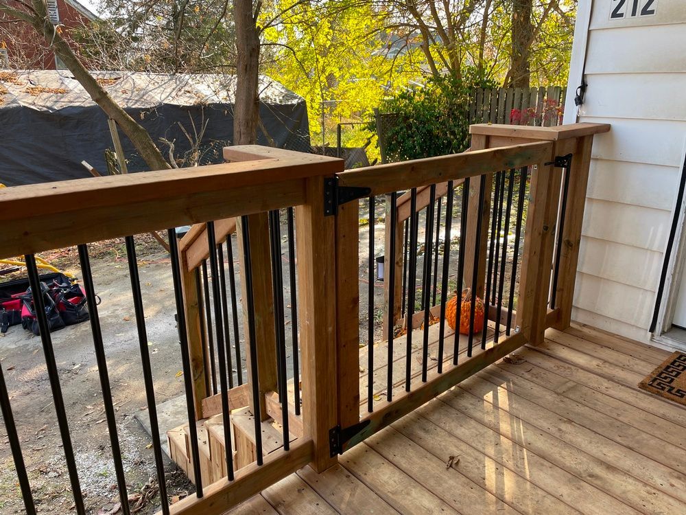 A wooden deck with a metal railing and stairs leading up to it.