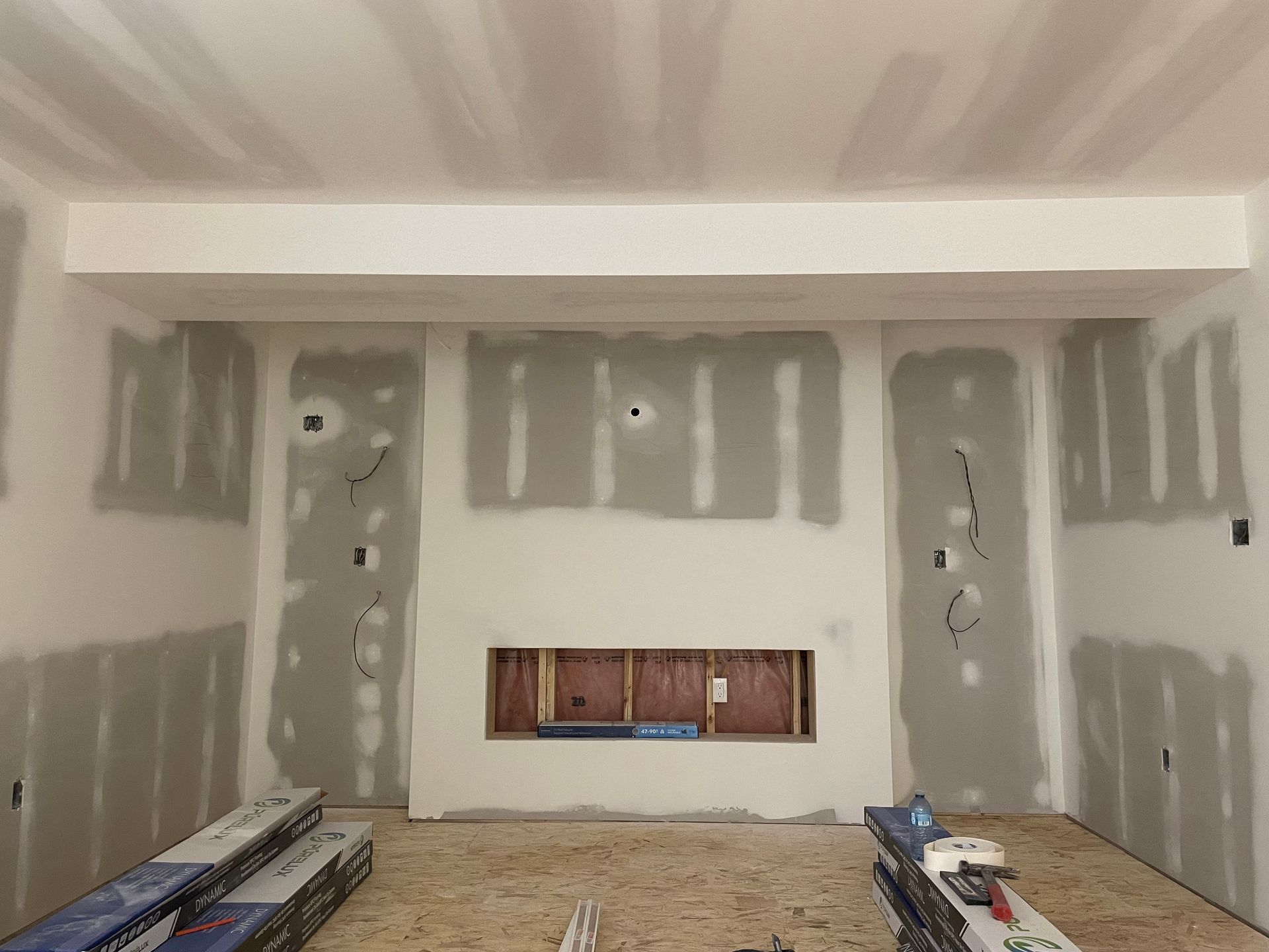 A room that is being remodeled with drywall on the walls.