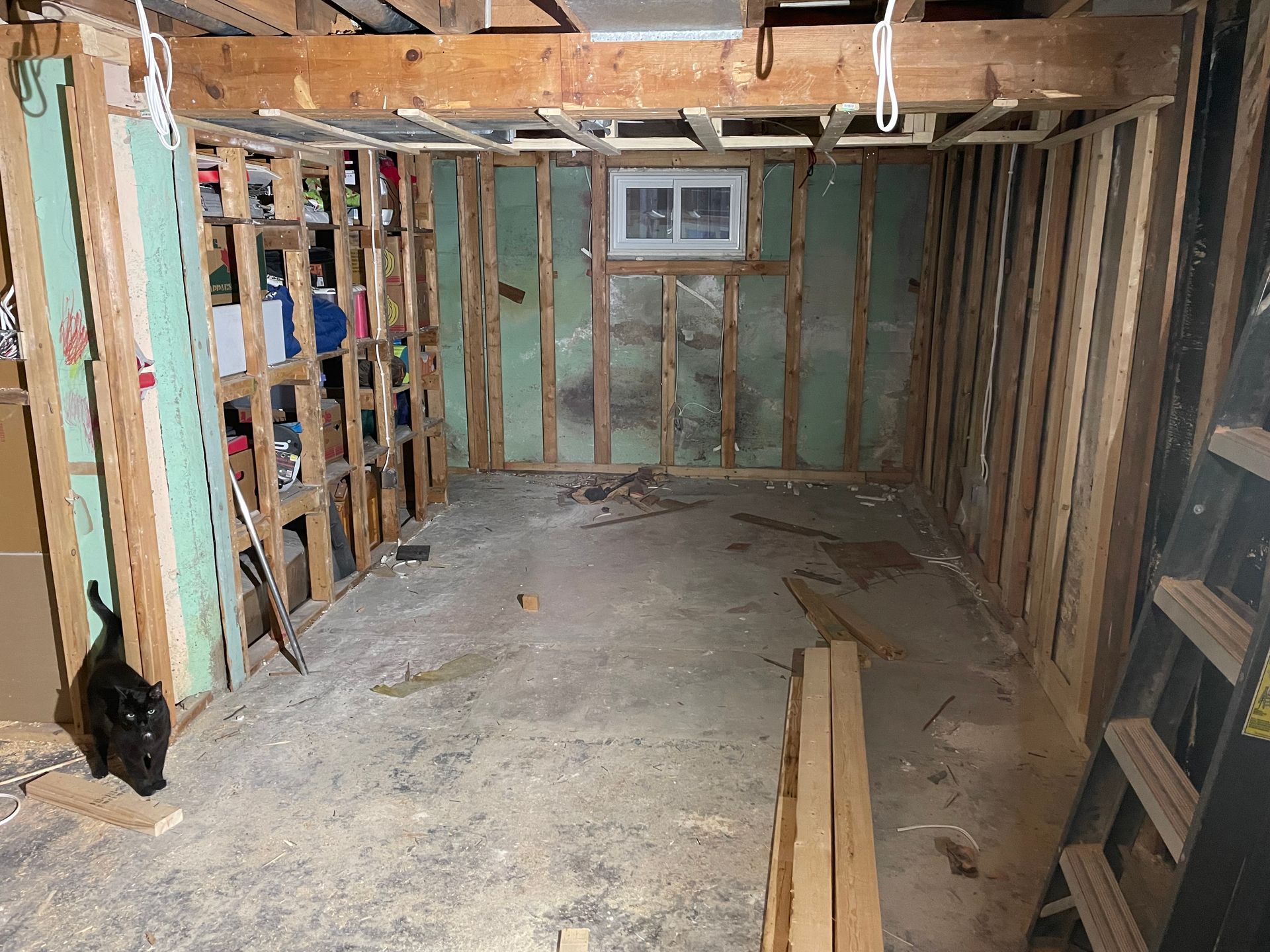 A room with wooden walls and a ladder in it.