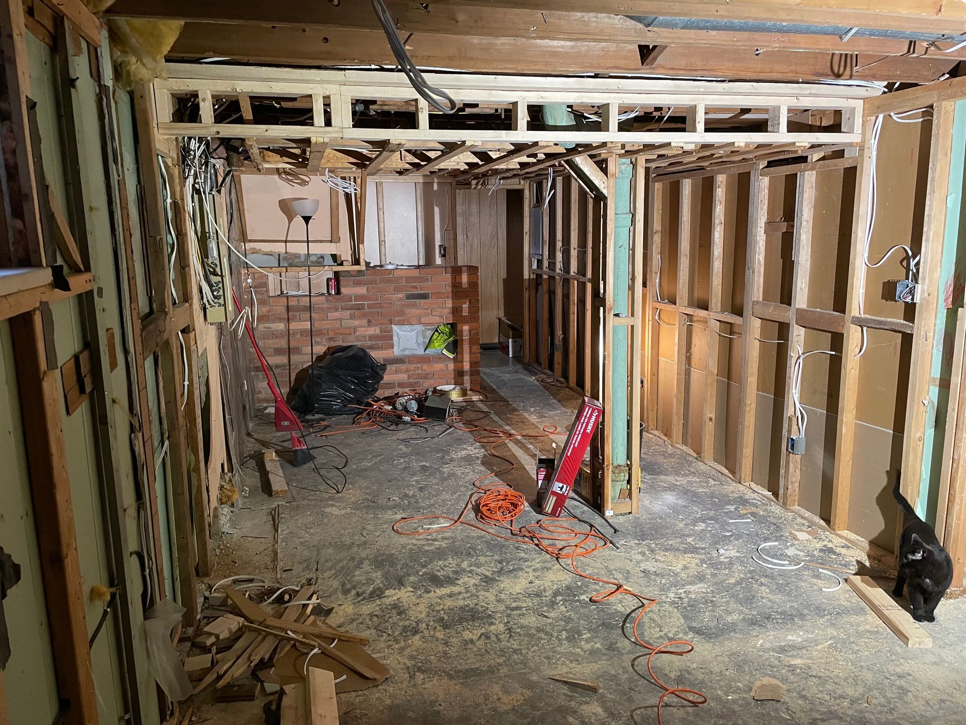 A room that is being remodeled with a lot of wood and bricks.