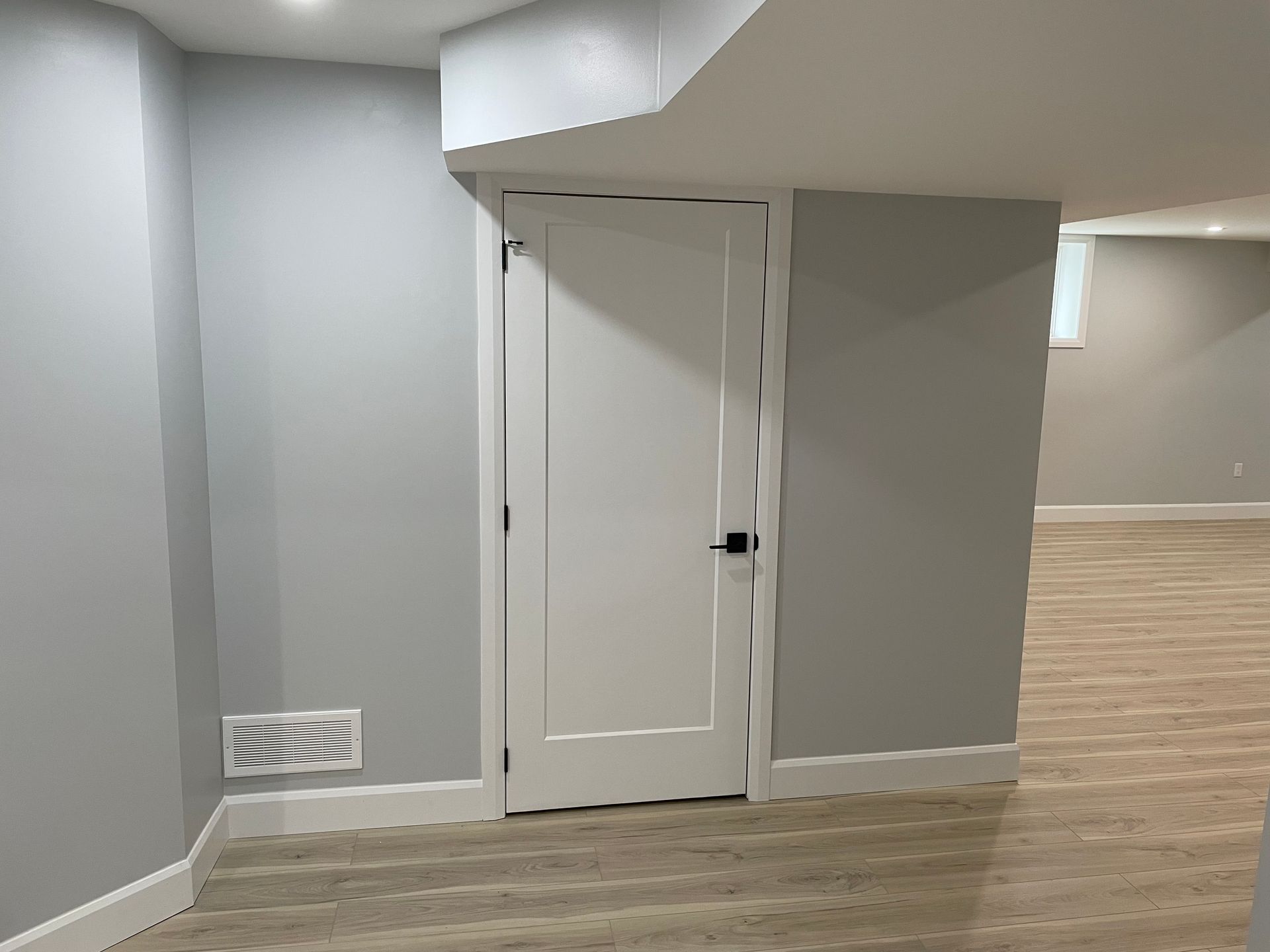 There is a door in the corner of the room.