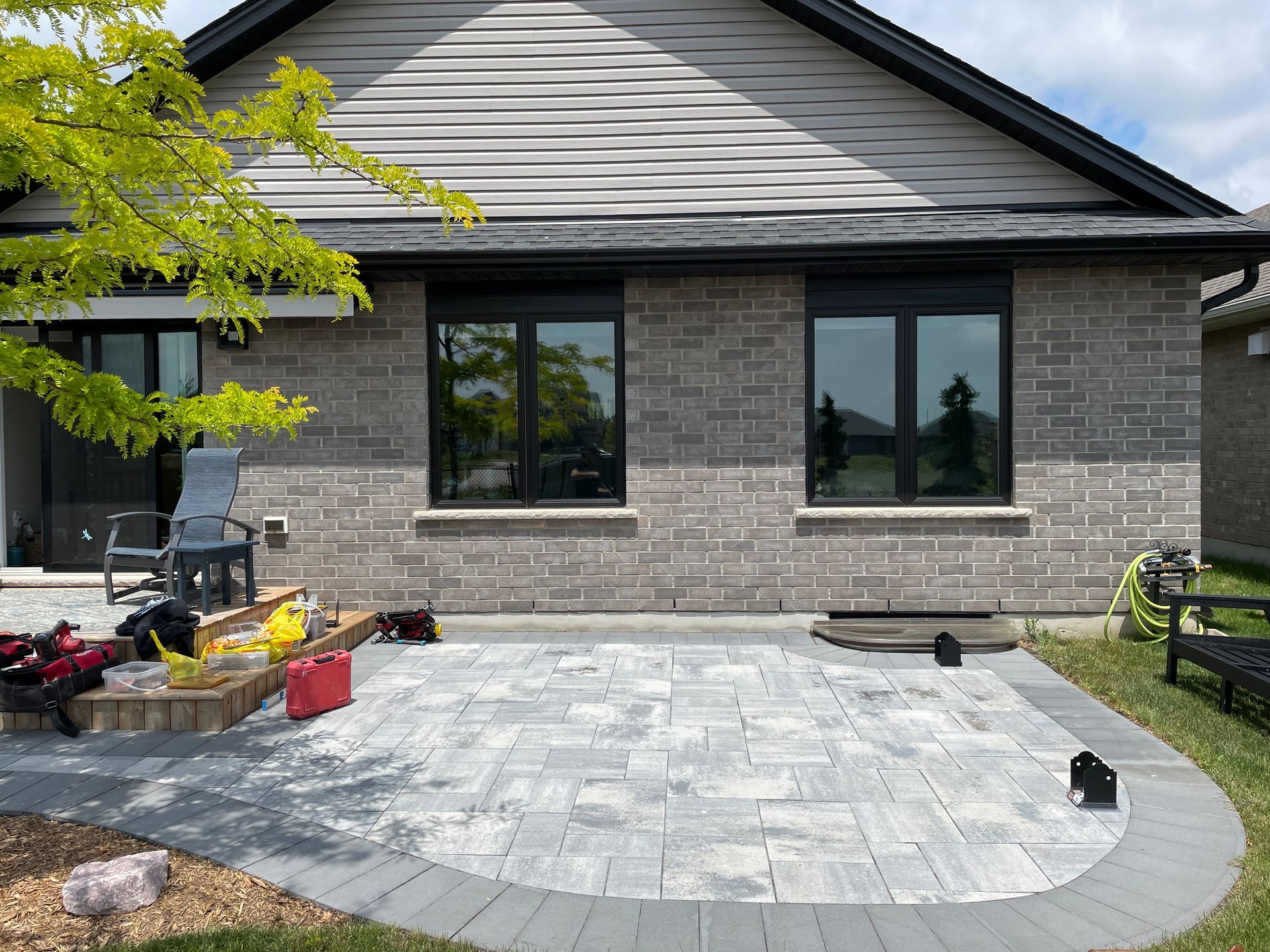A brick house with a patio in front of it.