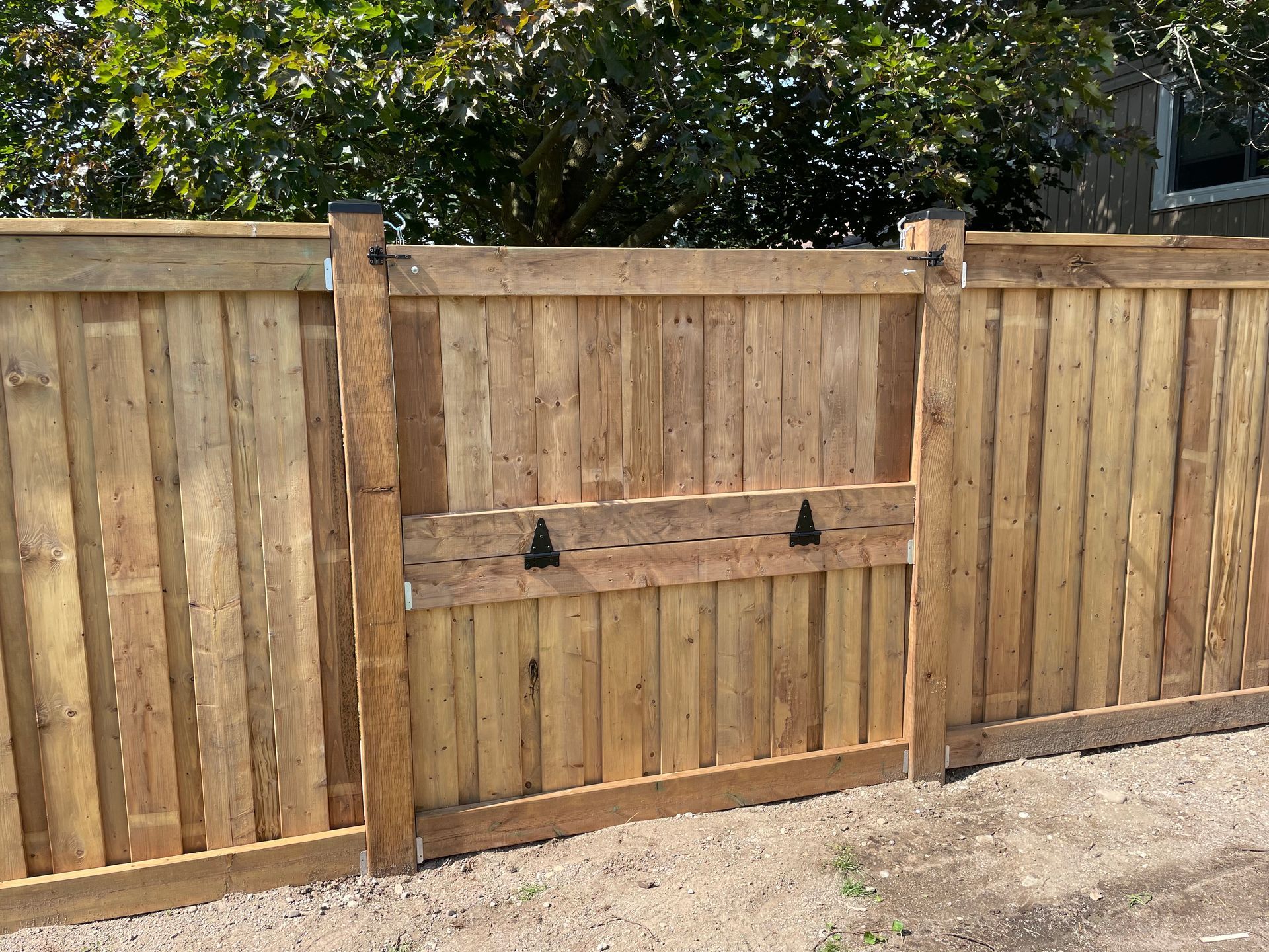 A wooden fence with a gate attached to it.