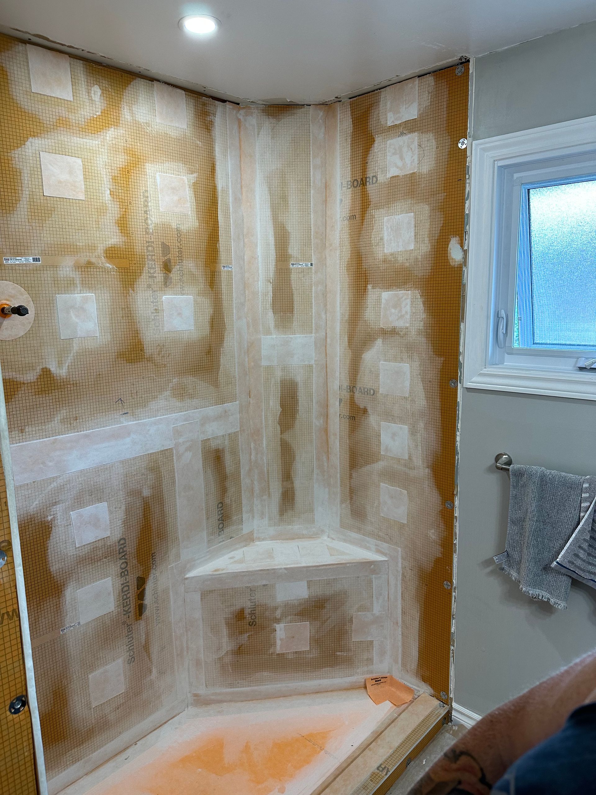 A shower stall is being remodeled in a bathroom.