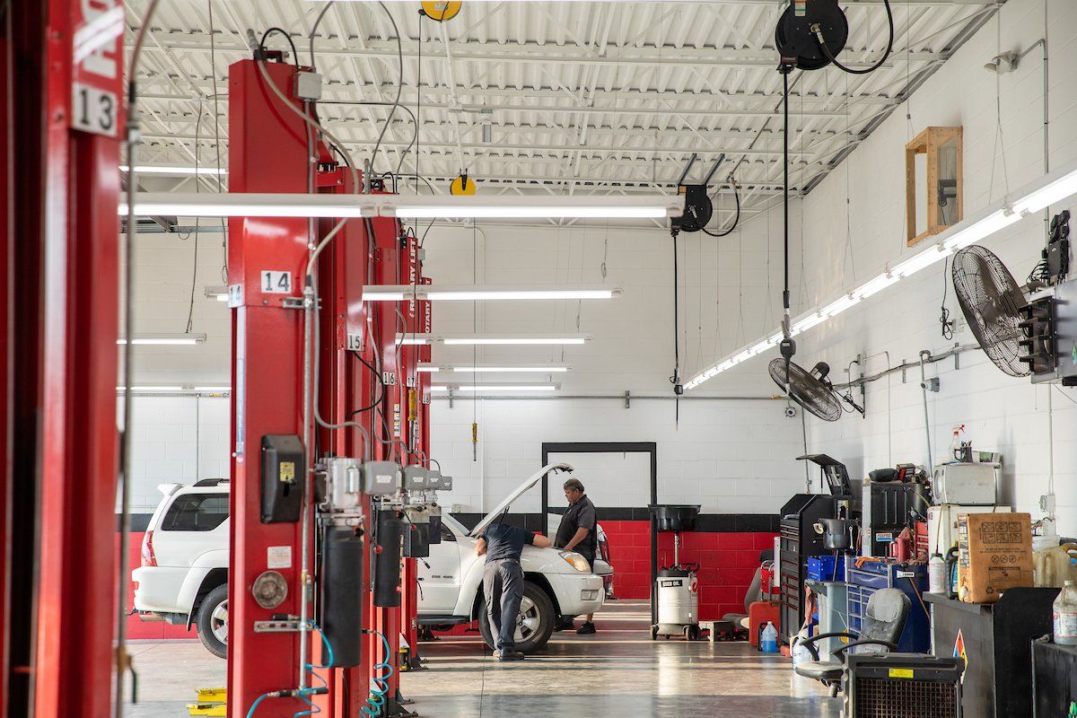 A man is working on a car in a garage.
