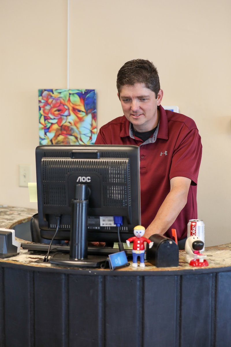 A man sitting at a desk with an aoc computer monitor