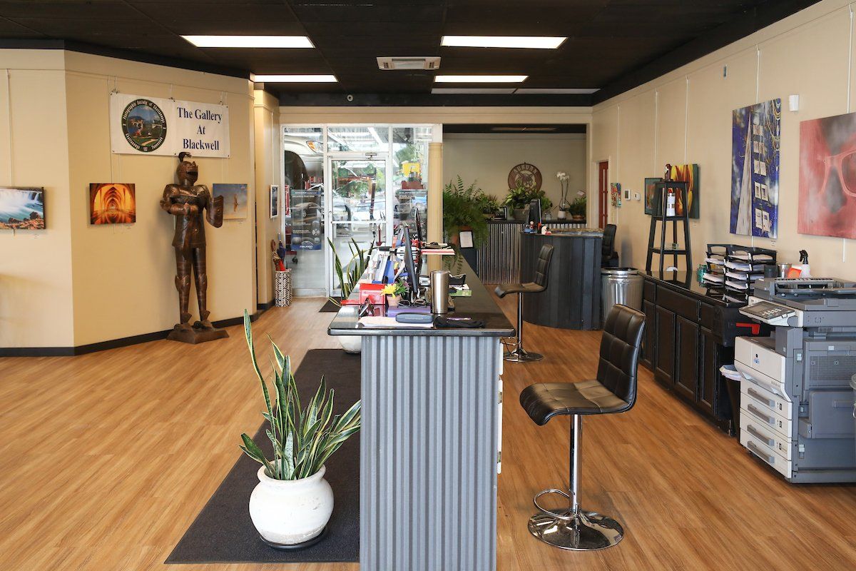 A large room with a desk and chairs in it