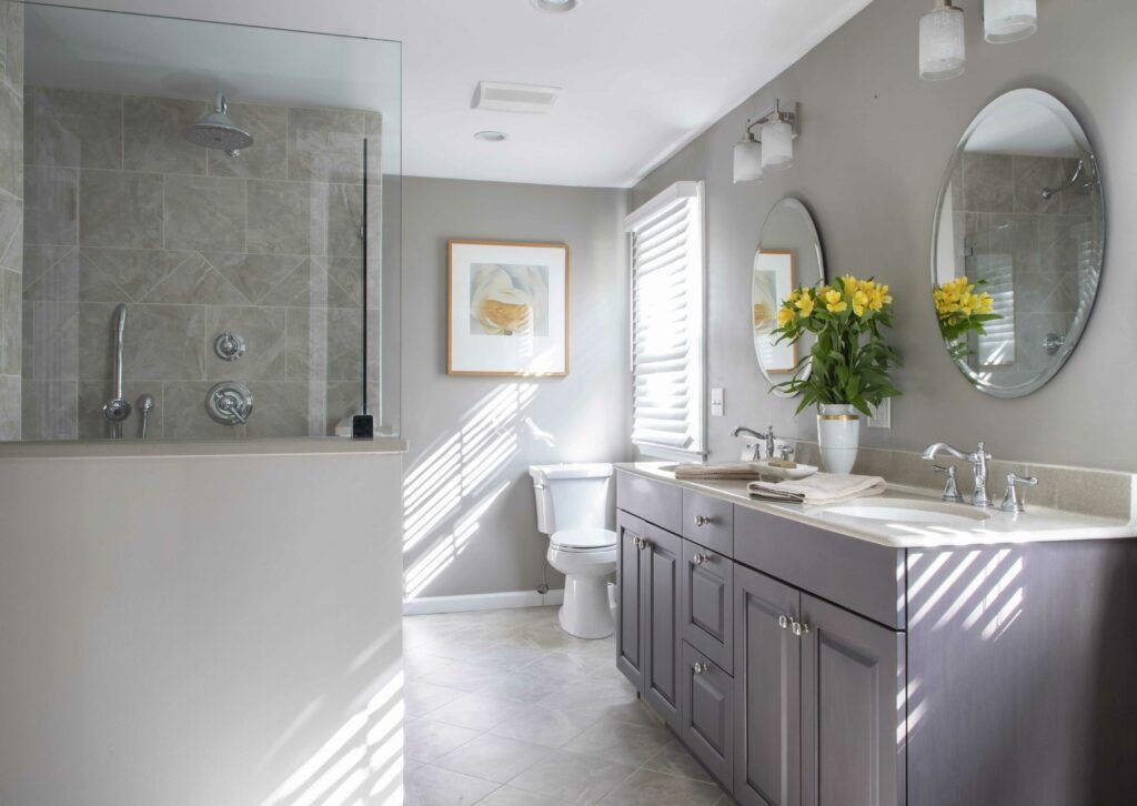 A bathroom with two sinks , a toilet , and a shower.